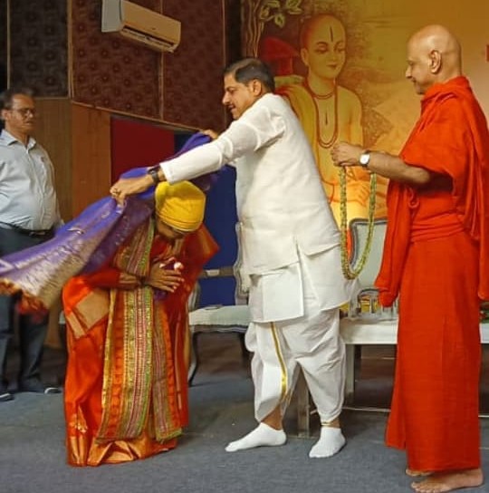 Honoured with a shawl during a felicitation