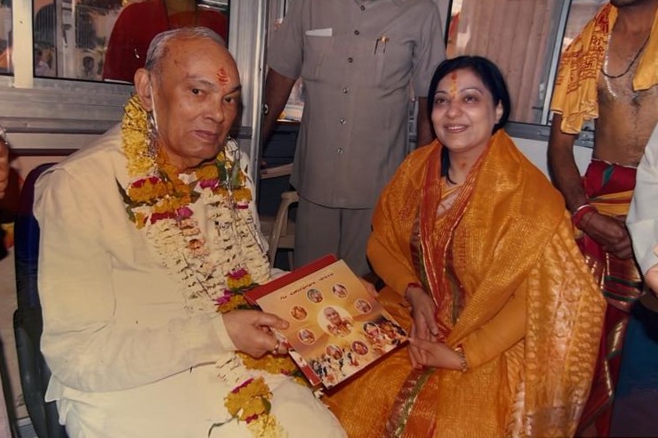 With a garlanded senior guest, presented a commemorative album
