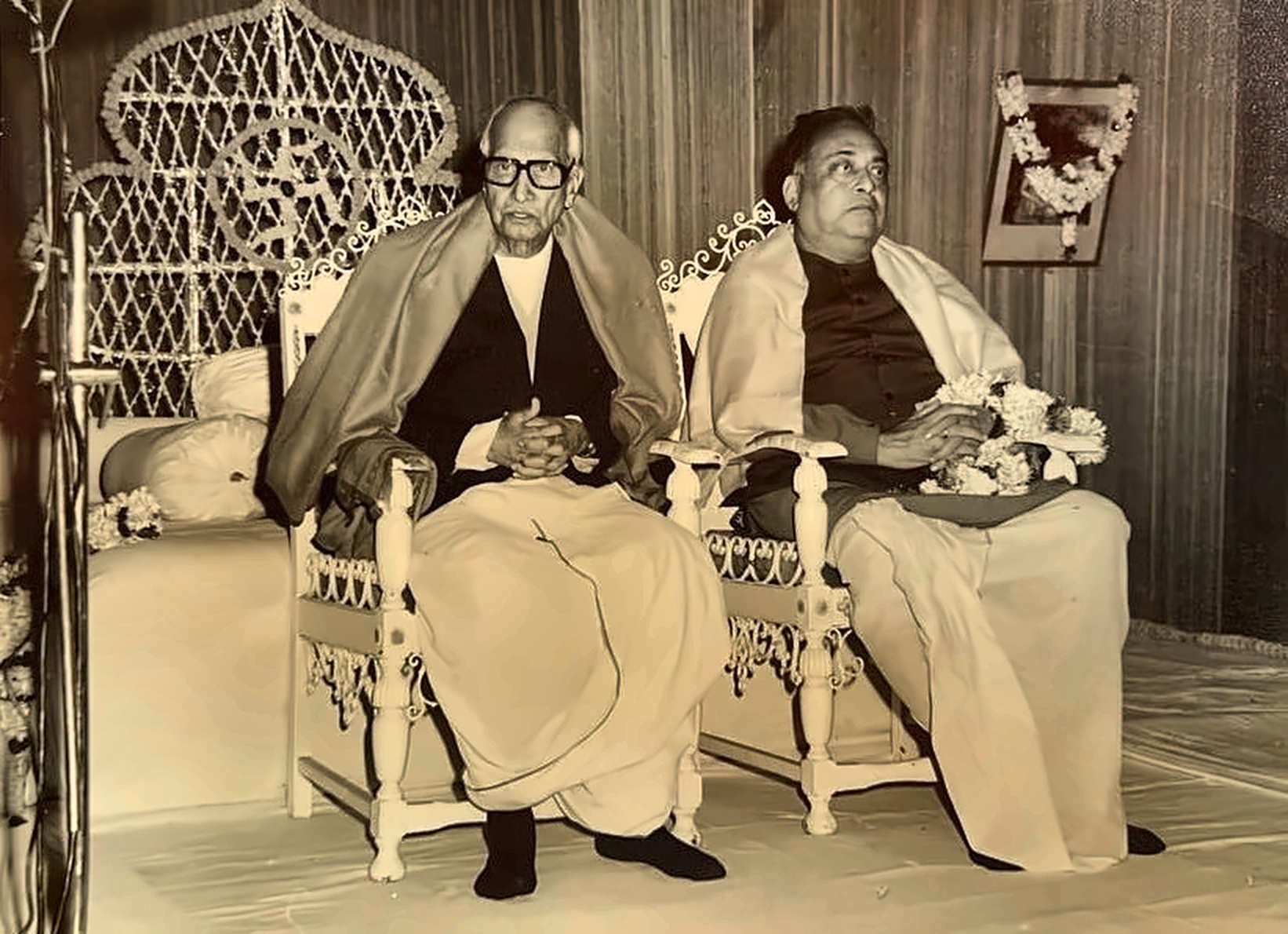 Seated beside a revered elder at a function