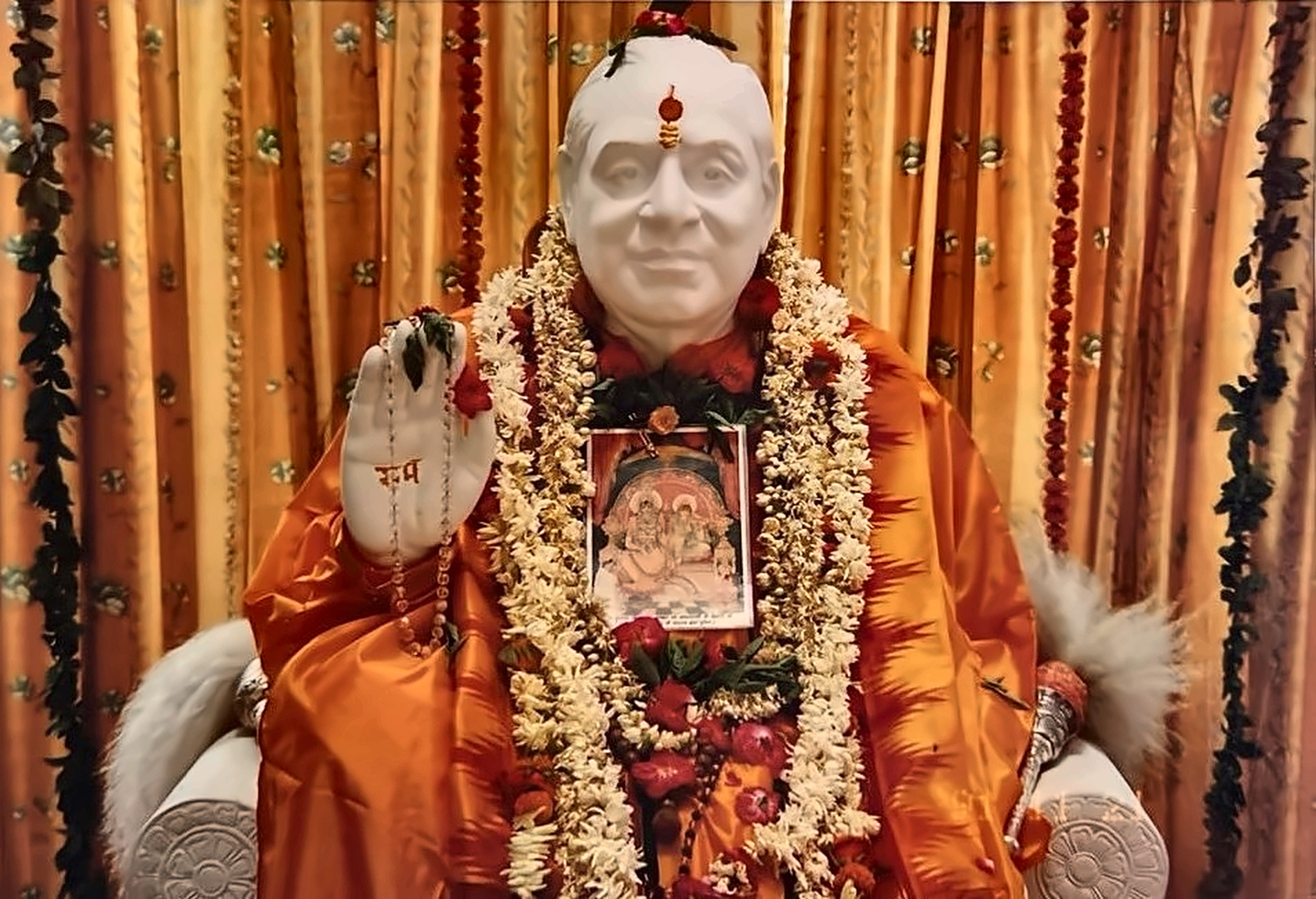 The sacred marble murti of Maharajshree, enshrined and adorned