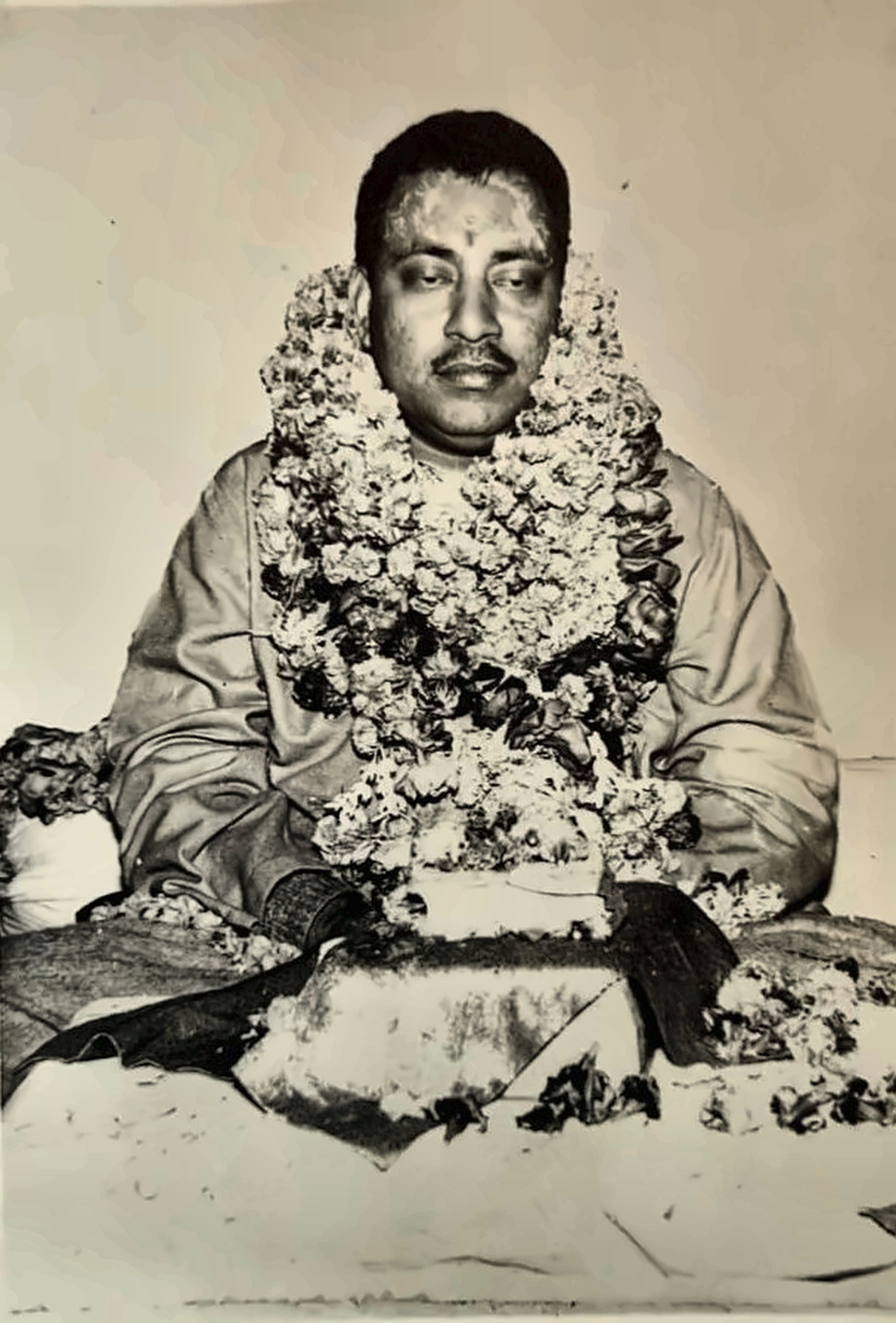 A younger Maharajshree, garlanded in honour